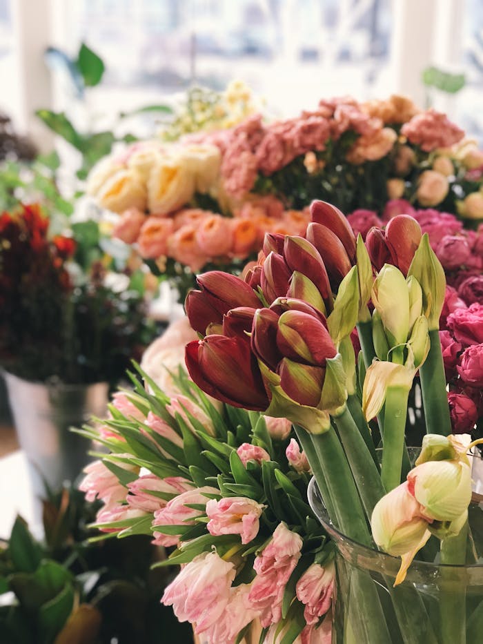 A stunning arrangement of fresh, vibrant flowers in various colors and types, set indoors.